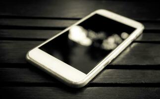 smart telefon med tom skärm liggande på tabell foto