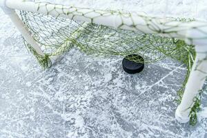 hockey puck i de mål netto närbild foto