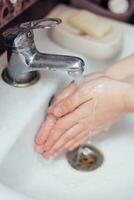 barn tvättar händer i handfat. tvättning ofta med ett antiseptisk tvål, virus skydd. begrepp av hand tvättning, hygien. coronavirus begrepp. covid19. foto