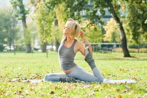 skön kvinna utövar yoga utomhus- foto