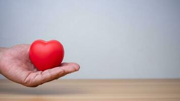 Bra hälsa och försäkring begrepp, hälsa försäkring begrepp. mänsklig hand innehav röd hjärta. foto