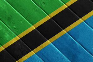 flagga av förenad republik av tanzania på en texturerad bakgrund. begrepp collage. foto