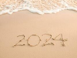 2024 år skriven på de strand i de solnedgång tid. ny år 2024 begrepp foto