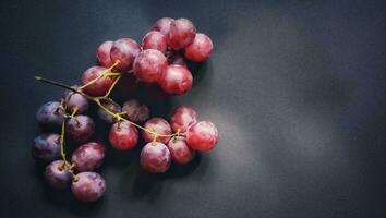 topp se av vitis vinifera frukt eller röd vindruvor isolerat på en svart bakgrund foto
