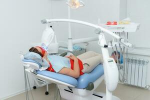 de patient genomgår en procedur för tänder blekning med ett ultraviolett lampa foto