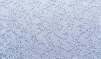 delikat blå spets med blommig prydnad festlig textil- abstrakt bakgrund. lyx klänning textilier. mockup. foto
