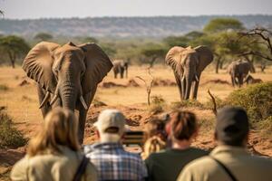 ai genererad grupp av turister tittar på elefanter i tsavo öst nationell parkera, kenya, en grupp av ung människor Kolla på och fotografera vild elefanter på en safari Turné i en nationell parkera, ai genererad foto