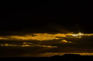 en mörk och molnig solnedgång foto