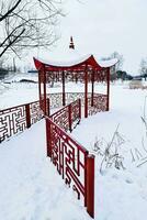 japansk stil röd lusthus på vinter- dag. foto