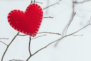 valentines dag begrepp. hand göra garn röd hjärta bredvid trä- blockera kalender uppsättning på valentines datum 14 februari på tabell och ljus rum bakgrund. Lycklig valentine dag. foto