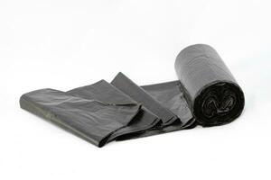 svart polyeten sopor påsar på vit bakgrund närbild. de rulla av plast skräp paket foto