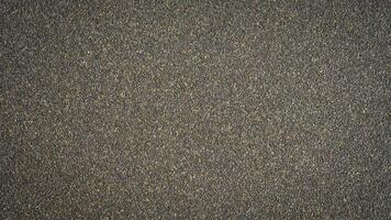 grov spannmål brun svart sand papper bakgrund textur foto