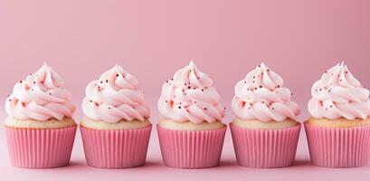 ai genererad muffins med rosa glasyr är i en rad på en rosa bakgrund foto