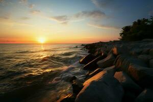 ai genererad tropisk skymning solnedgång kastar en värma glöd på de klippig Strand foto