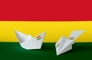 bolivia flagga avbildad på papper origami flygplan och båt. handgjort konst begrepp foto