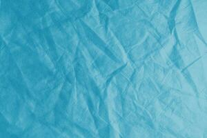 rynkig, skrynkliga blå spunbond tyg textur bakgrund foto