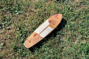 en trä- skateboard på de gräs foto