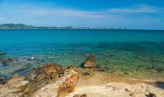 landskap sommar frontvy panorama tropisk havs strand sten blå himmel vit sand bakgrund lugna natur hav skön Vinka krascha stänk vatten resa khao leam ya nationell parkera öst thailand exotisk foto