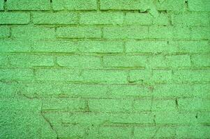 grön målad tegel vägg bakgrund. foto