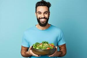 ai genererad Lycklig ung vegetarian Framställ på blå vägg med glas skål av färsk organisk grönsaker foto