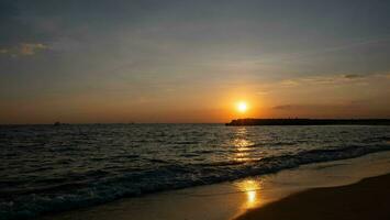 solnedgång på de hav med en lång strand foto