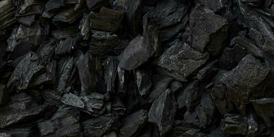 svart kol bakgrund. träkol vedartad svart. massa av trä foto