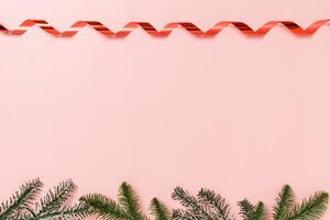 minimal kreativ lägenhet av julens traditionella komposition och nyårshelger. ovanifrån vinter juldekorationer på rosa bakgrund med tomt utrymme för text. kopiera rymdfotografering. foto