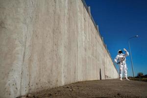 futuristisk astronaut i en hjälm mot gråa väggar foto