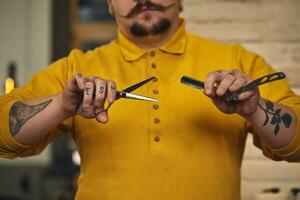 eleganta barberare man med frisering verktyg i hans händer förbereda för arbete foto