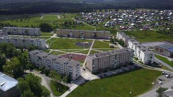 se från de höjd av de helikopter . klämma. små hus Nästa till stor träd och parker , som väl som en väg på som en få bilar kör foto