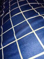 närbild av blå och vit rutig servett eller picknick bordsduk textur, kök Tillbehör. foto