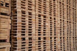 bakgrund av lastpall trä i lager. mönster trä sektion. rutnät av trä rutor. de rå av material timmer på stack. foto