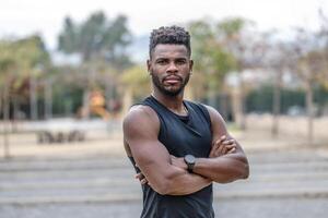 självsäker afrikansk amerikan sportsman med vapen korsade foto