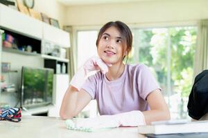 asiatisk kvinna rena på de levande rum, lägenhet eller Hem område foto