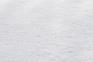 vit rena skinande snö bakgrund textur. färsk snö sömlös textur. snöig yta närbild foto