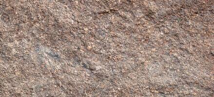 textur av grov granit sten yta bakgrund foto