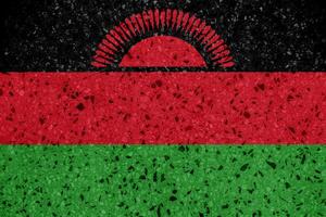 flagga av republik av malawi på en texturerad bakgrund. begrepp collage. foto