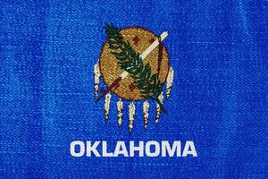 flagga av Oklahoma stat USA på en texturerad bakgrund. begrepp collage. foto