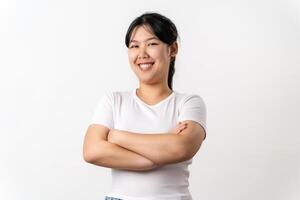 de Söt och Lycklig asiatisk ung kvinna är leende självsäkert stående på en vit bakgrund. foto