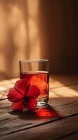 ai genererad elegant glas av te med vibrerande röd hibiskus blomma foto