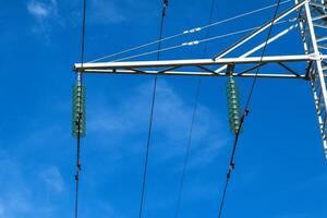 stöder högspänning kraft rader mot de blå himmel med moln. elektrisk industri foto