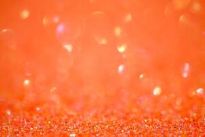 pärlar defokusering ljus. glitter papper defokusering som bakgrund. orange. foto