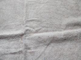 textur, mönster, bakgrund av smutsig vit handduk utsatt till solljus foto