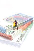miniatyr- affärsman navigerar de finansiell landskap, omgiven förbi euro sedlar, foto