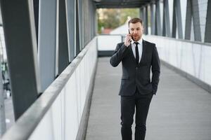 affärsman använder sig av smartphone i täckt gångväg. foto