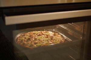hemlagad pizza är bakad i en modern elektrisk ugn. foto