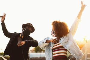 afro amerikan vänner bär ansikte skyddande mask håller på med ny social distans hälsningar skumpande armbågar - ungdom tusenåriga människor och hälsa vård riktlinjer till undvika korona virus spridning foto