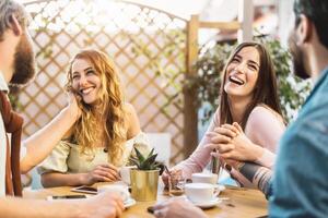 Lycklig vänner dricka cappuccino i cafeteria bar - ung romantisk par har roligt delning tid tillsammans - kärlek relation och social sammankomst människor livsstil begrepp foto