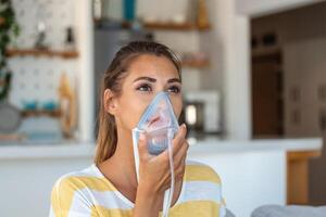 sjuk kvinna framställning inandning, medicin är de bäst medicin. sjuk kvinna bär ett syre mask och genomgå behandling för covid19. kvinna med ett inhalator foto