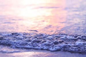 mjuk Vinka av de hav på de sandig strand på solnedgång tid. foto